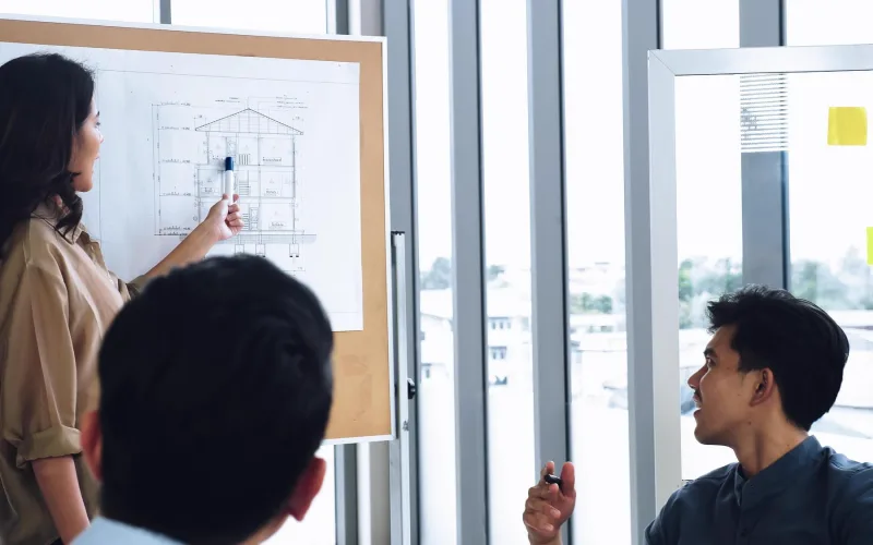 A development team collaborating on a screen in a bright office